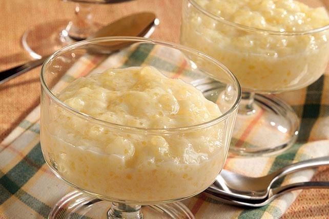 Creamy tapioca pudding in clear glass dessert bowls on a plaid napkin.