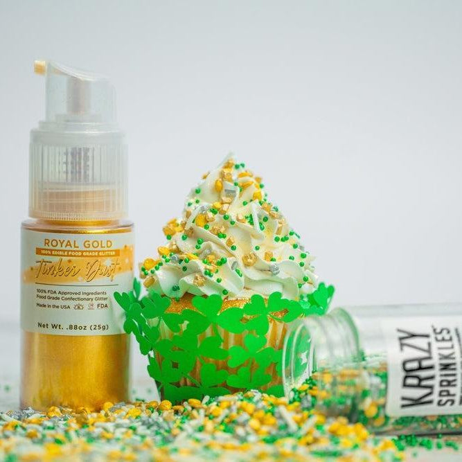 Gold edible glitter spray next to a cupcake with green sprinkles and a "Krazy Sprinkles" container.