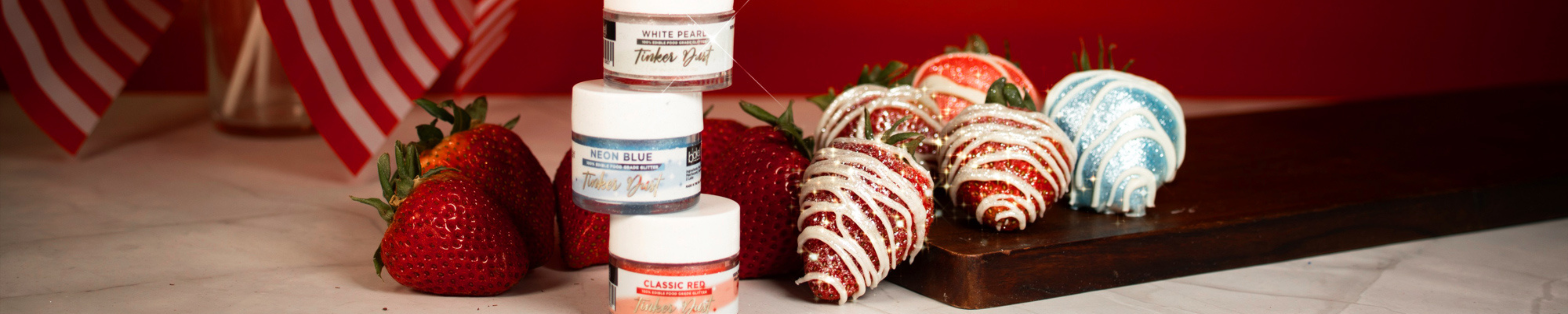 Strawberries with red, white, and blue edible glitter and luster dust, perfect for patriotic desserts.