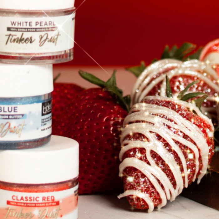 Strawberries with red, white, and blue edible glitter and luster dust, perfect for patriotic desserts.