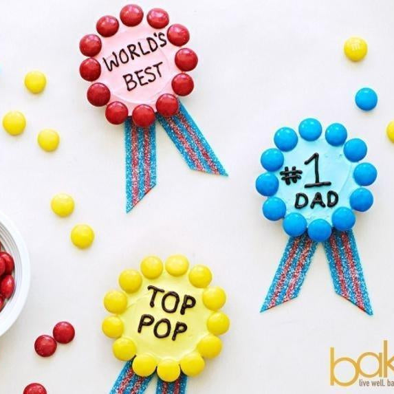 Colorful "World's Best," "#1 Dad," and "Top Pop" candy medals with striped ribbons.