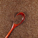 Antique gold ultrafine metallic craft glitter with a wooden spoon holding a scoop.