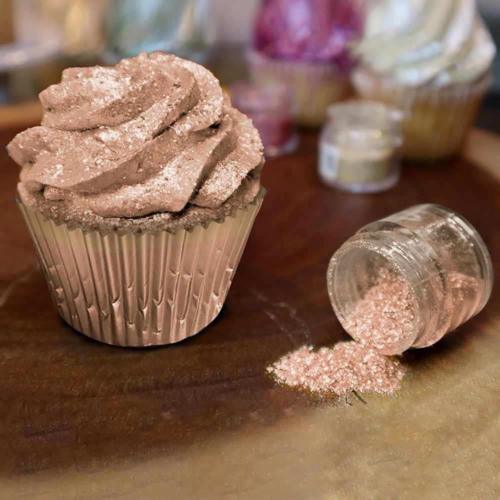 Front view of a cupcake covered in Rose Gold edible glitter, and a spilled jar of the glitter to the right. | bakell.com
