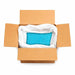 Open cardboard box with a large white bag containing 132lb of sparkling baby blue ultrafine iridescent glitter.