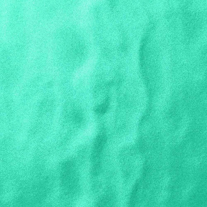 Close-up of vibrant, ultrafine UV reactive iridescent craft glitter in a bright teal color.