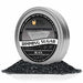 Brew Glitter Black Rimming Sugar in a silver tin, surrounded by a pile of black sugar crystals.