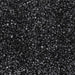 Coarse black cocktail rimming sugar crystals with a sparkling, granular texture for decorating glassware.