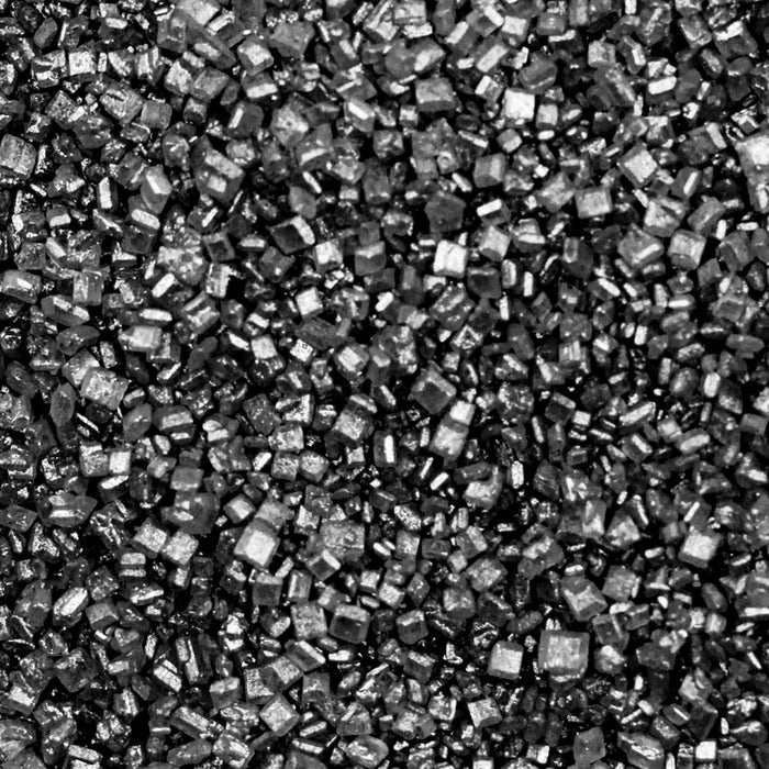 Close-up of sparkling black rimming sugar crystals for cocktail garnishes.