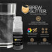 Black Shimmer edible beverage glitter in a mini spray pump next to a glass of water.
