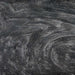 Swirling black edible glitter creating a shimmering, galaxy-like effect in a beverage.