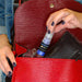 A close up of a woman's hand, putting Blue Edible Drink Glitter in her purse. | bakell.com