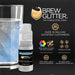Blue color-changing beverage glitter in a mini spray pump next to a glass of water.