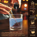 Hand pouring white color-changing brew glitter into a glass of water, turning it sparkling blue.