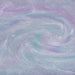 Swirling blue and purple iridescent edible glitter creating a holographic, shimmery liquid effect.