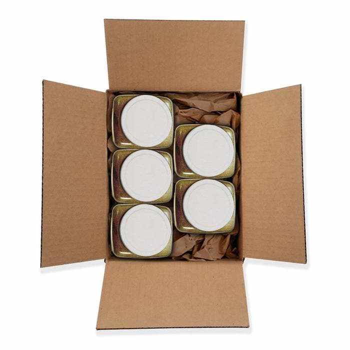 Open cardboard box containing five 1kg jars of Bright Gold Tinker Dust® Glitter, packed with brown paper.