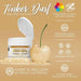 Bright gold Tinker Dust edible glitter jar next to a gold-dusted cherry.