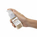 Front View of a hand holding a 25 gram Brown Edible Glitter Spray Pump. | bakell.com