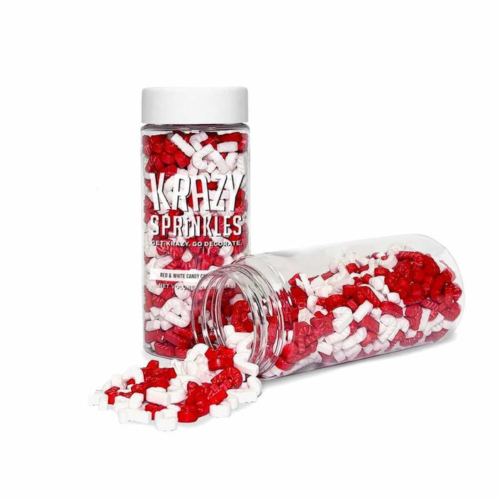 Red and white candy cane shaped sprinkles in clear plastic jars with white lids.