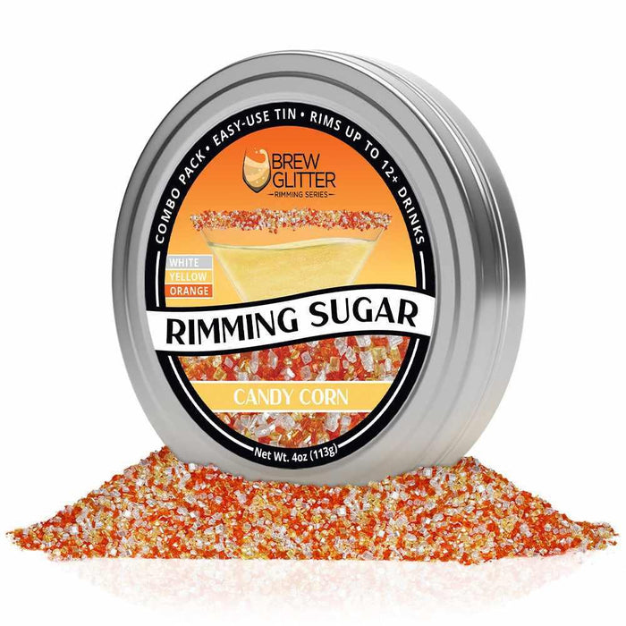 Candy Corn Rimming Sugar in a silver tin, surrounded by white, yellow, and orange sugar crystals.