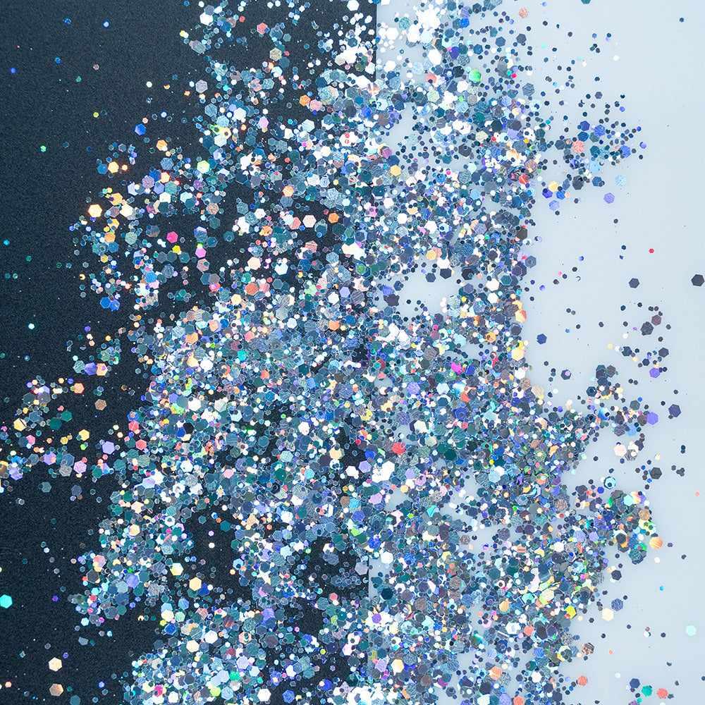 Chunky rainbow holographic hexagon mix craft glitter, sparkling on a black and white background.