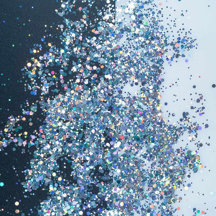 Chunky rainbow holographic hexagon mix craft glitter, sparkling on a black and white background.