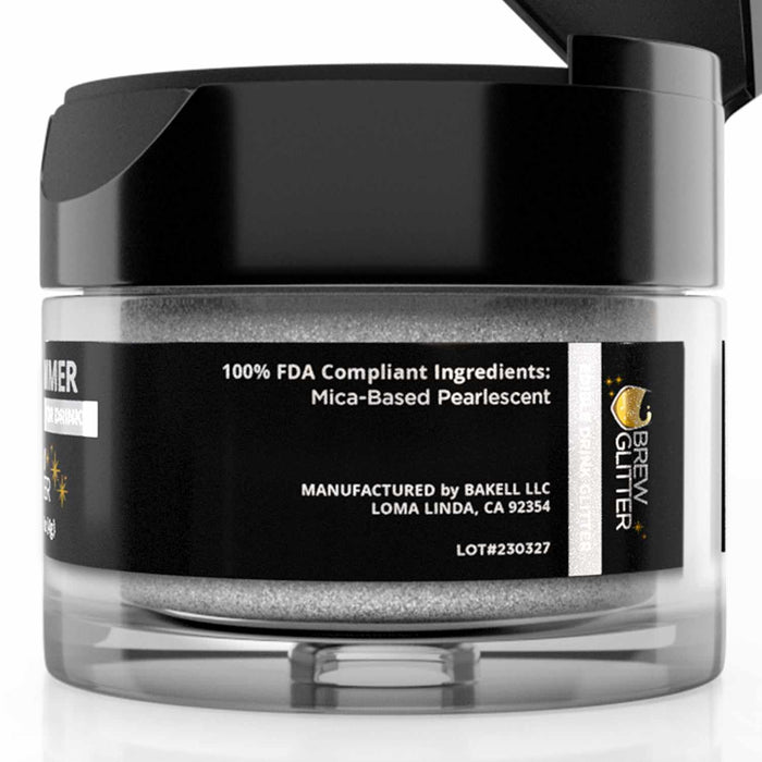 4g jar of clear shimmer edible drink glitter with a black flip-top cap and label detailing mica-based pearlescent ingredients.