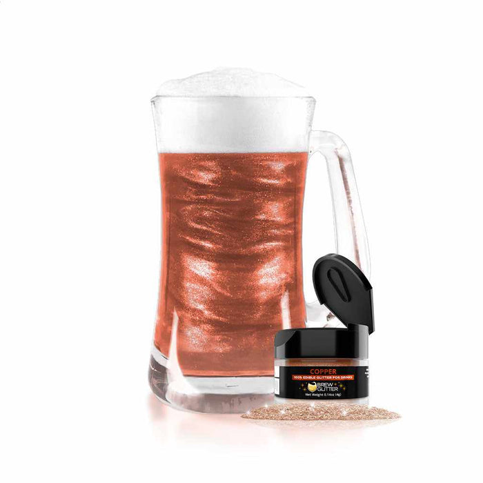 product shot of beer stein filled with copper glitter drink next to a jar
