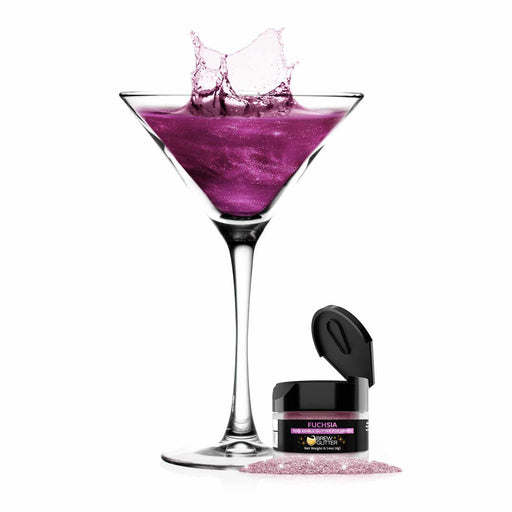 product shot of fuchsia martini glass next to a jar