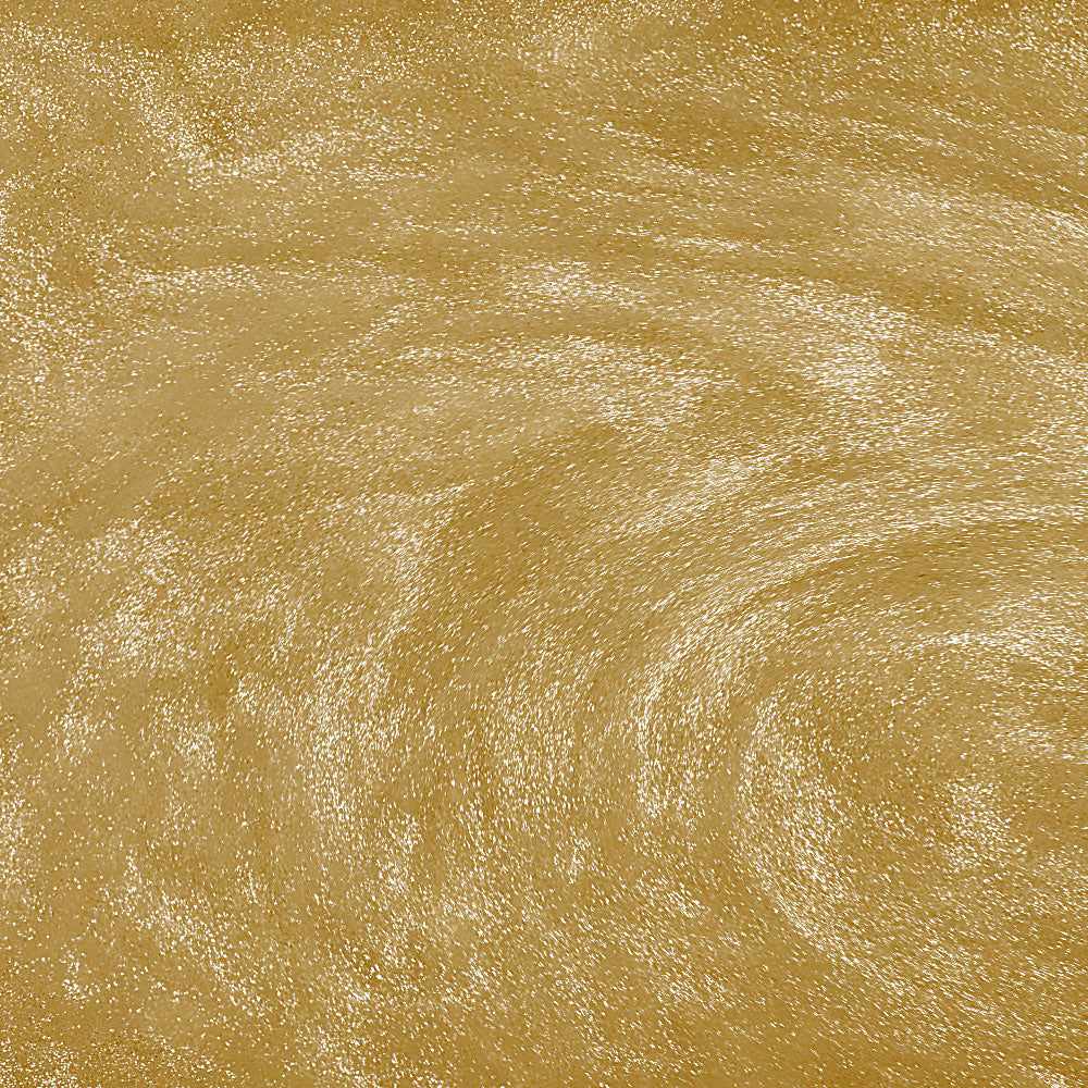 Swirling gold edible glitter particles creating a shimmering, metallic texture in a liquid beverage.