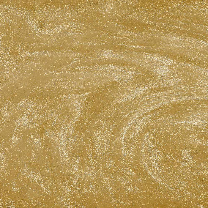 Swirling gold edible glitter particles creating a shimmering, metallic texture in a liquid beverage.