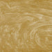 Swirling gold edible glitter particles creating a shimmering, metallic texture in a liquid beverage.