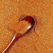 Golden Egg ultrafine UV reactive metallic craft glitter with a wooden spoon.
