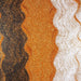 Wavy lines of Golden Egg ultrafine UV reactive metallic craft glitter, black, and white Dazzler Dust.