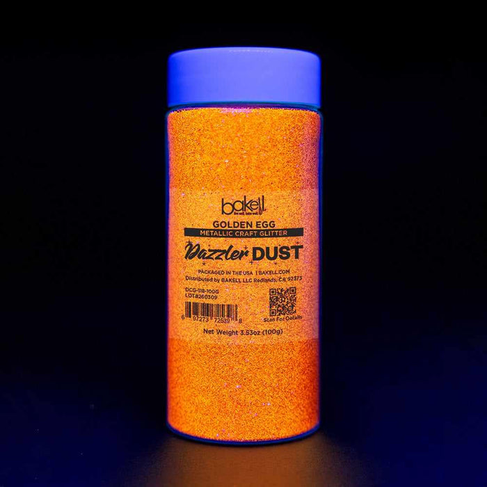 Golden Egg Ultrafine UV Reactive Metallic Craft Glitter Dazzler Dust in a clear jar with a blue lid.
