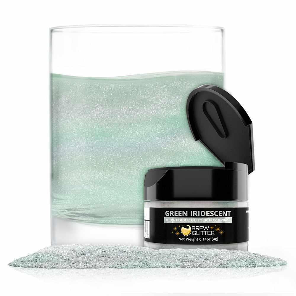 Green iridescent edible brew glitter in a jar with a glass of shimmering green liquid and loose glitter.