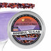 Halloween Rimming Sugar tin with black, purple, and orange sugar on a cocktail glass.