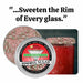 Holiday Rimming Sugar in a silver tin, featuring red, green, and white sprinkles on a glass rim.