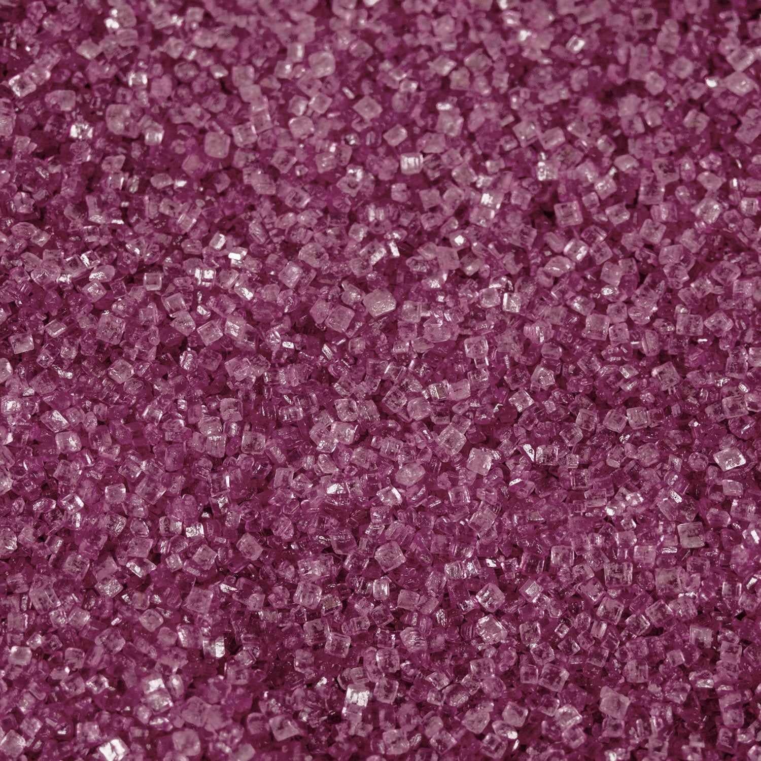 Close-up texture of vibrant hot pink cocktail rimming sugar crystals with a sparkling, granulated finish.