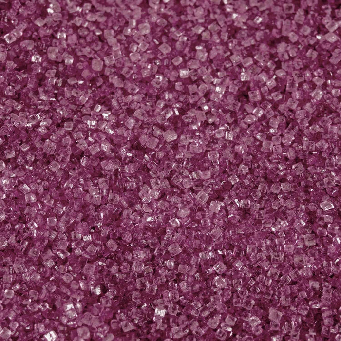 Close-up texture of vibrant hot pink cocktail rimming sugar crystals with a sparkling, granulated finish.