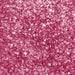 Close-up of sparkling hot pink rimming sugar crystals, perfect for garnishing drinks.