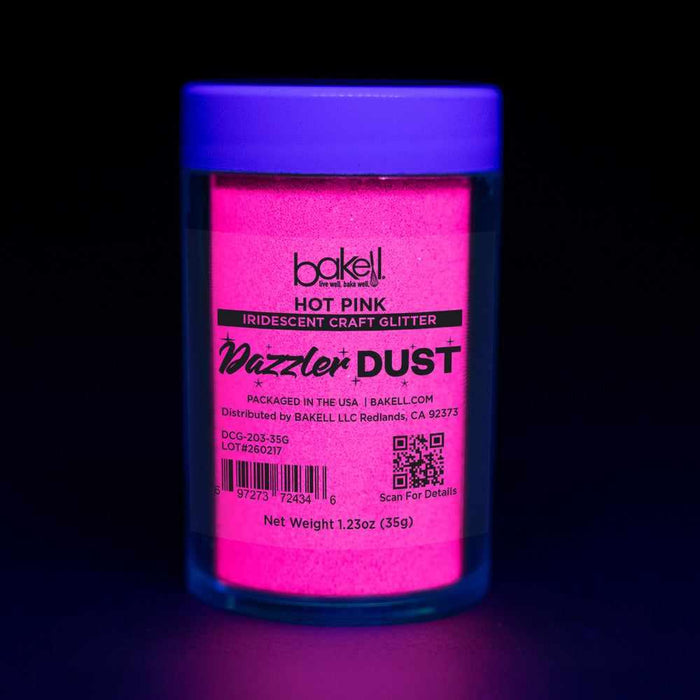 Hot pink ultrafine UV reactive iridescent craft glitter in a clear jar with a glowing purple lid.