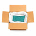 Open cardboard box with a white plastic bag containing 132lb of jade green ultrafine holographic craft glitter.