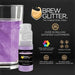 Light purple edible beverage glitter in a mini spray pump next to a glass of sparkling purple drink.