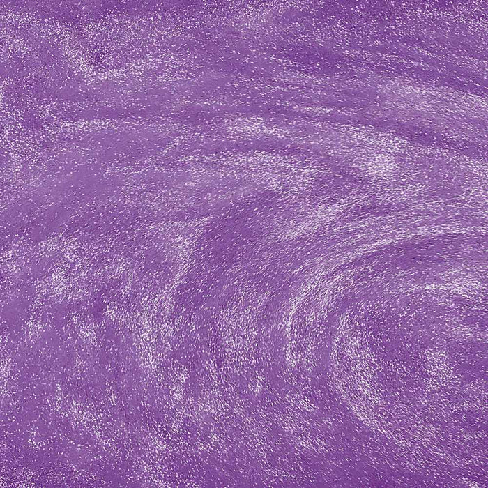 Swirling light purple edible drink glitter creating a shimmering, metallic texture in a beverage.
