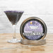 black glitter drink with a light purple sugar rim next to rimming tin