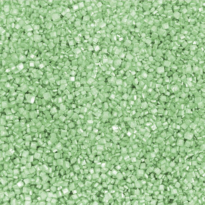 Close-up of sparkling mint green pearl cocktail rimming sugar with a shimmering, crystalline texture.