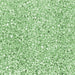 Close-up of sparkling mint green pearl cocktail rimming sugar with a shimmering, crystalline texture.