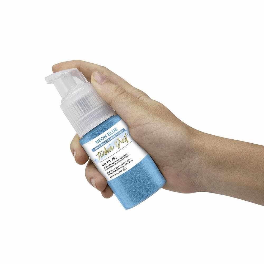 Hand holding a 25g pump bottle of Neon Blue Tinker Dust edible glitter spray.