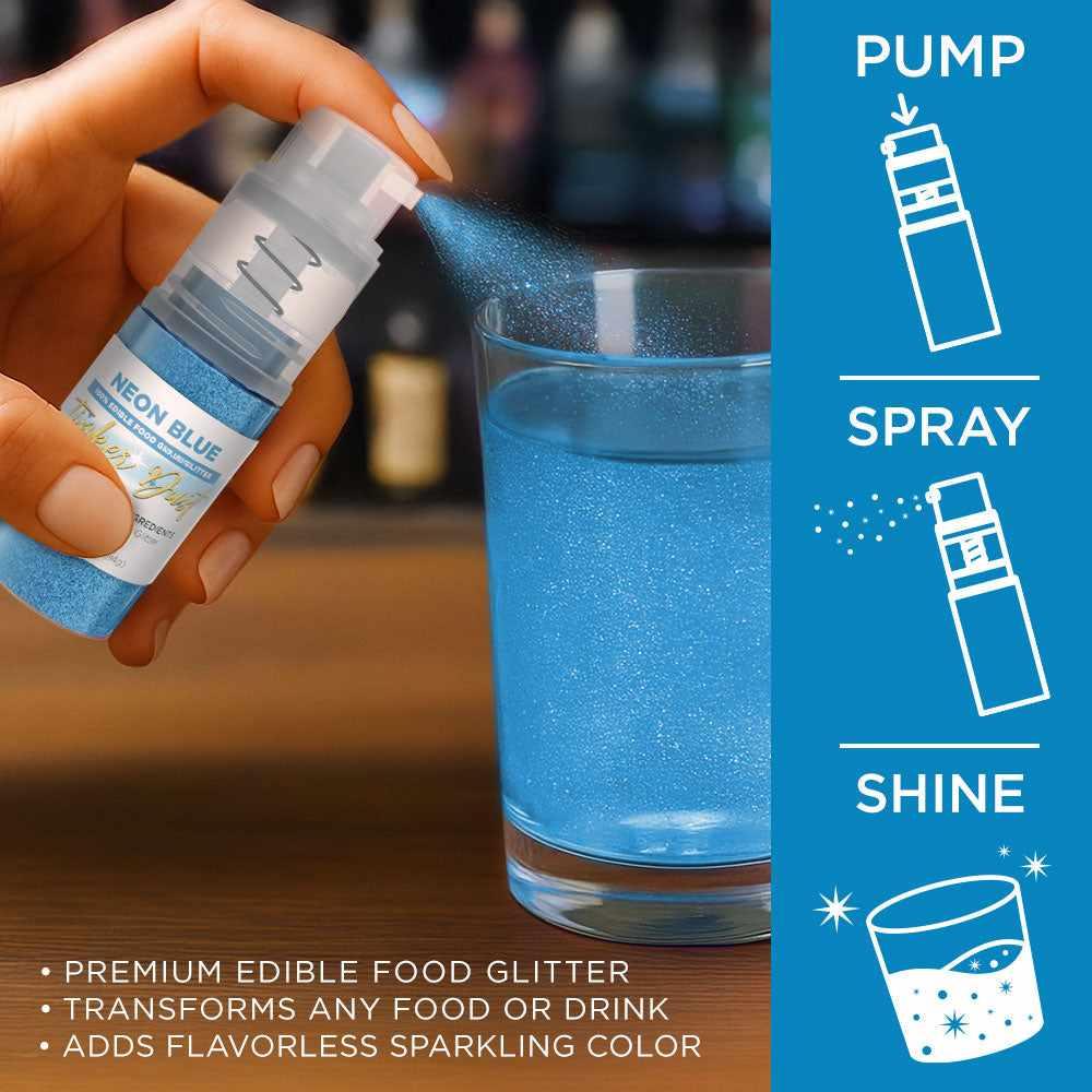 Hand spraying neon blue edible glitter from a 4g Tinker Dust pump onto a glass of blue liquid.