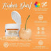 Neon Orange Tinker Dust edible glitter in a jar with a glitter-covered cherry on an orange background.